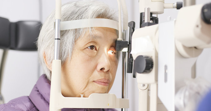 Old woman having her eyes examine