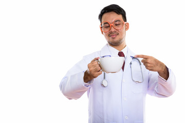 Studio shot of young Asian man doctor holding and pointing at co