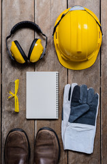 Standard construction safety equipment on wooden table. top view