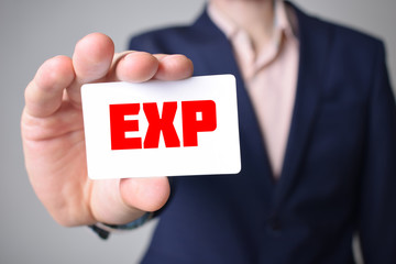 Businessman shows business card with the inscription:EXP
