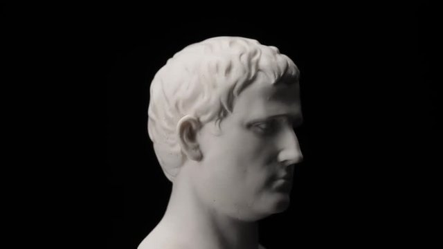 Ancient roman era white marble statue of Marcus Vipsanius Agrippa rotating and showing every angles. Closeup shot  with black background.