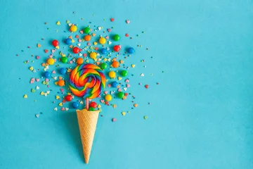 Foto op Plexiglas Ice cream cone with colorful lollipop and multicolored sweets. concept, , flat lay,  top view, copy space, © IRINA