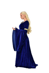 Naklejka premium full length portrait of pretty blonde lady wearing a blue fantasy medieval gown. standing pose on white background.