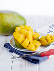 Ripe mango on the board chopped slices