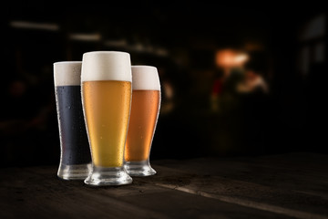 Different sorts of craft beer on rustic wooden