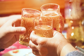 Clinking glasses of champagne in hands
