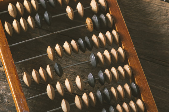 Vintage abacus on an wooden background photo