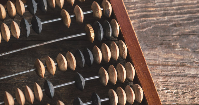 Vintage abacus on an wooden background photo