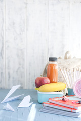 Lunch box with sandwich,apple and stationery isolated on white.