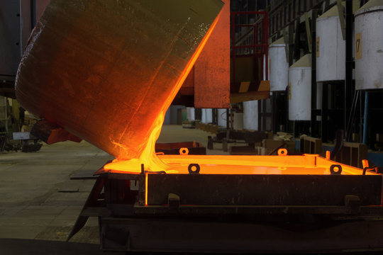 Pouring melted glass into mold in optical glass factory