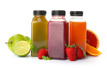 Bottles with healthy detox smoothies and ingredients on white background