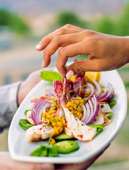 Woman selects prepared Summer Shrimp