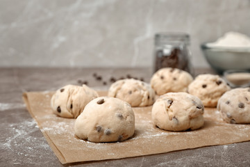 Fresh raw dough balls with chocolate chips on table