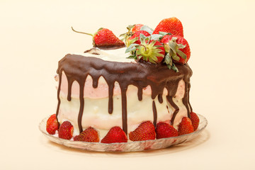 Homemade chocolate cake decorated with fresh strawberries on glass plate