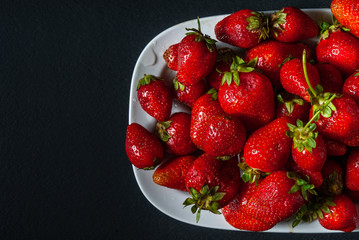 ripe strawberries on a black background