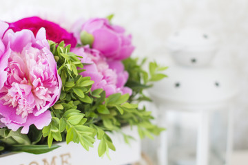 Bouquet of peonies. Peonies and roses. Peonies in a wooden box