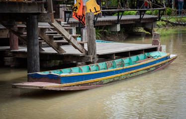 Fototapeta na wymiar blue wooden boat near wood quay