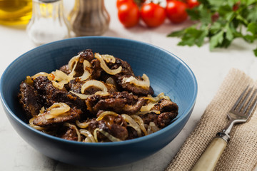 Fried chicken liver with onions.