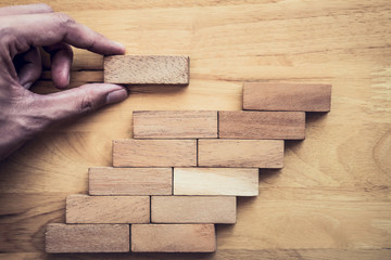 Business concept for growth success process, Images of hand of businesspeople placing and pulling wood block to complete in game and success in strategy