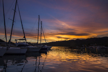 Fototapeta na wymiar panorama of colorful sunset on mediterranean sea with yachts