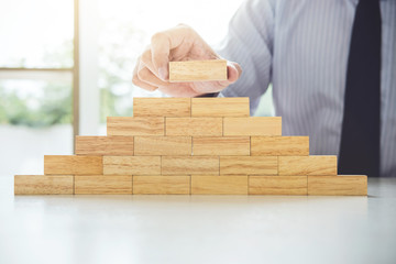 Plan and strategy in business, Risk To Make Business Growth Concept With Wooden Blocks, hand of man...