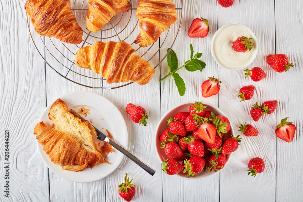 Wall mural freshly baked croissants with ripe berries