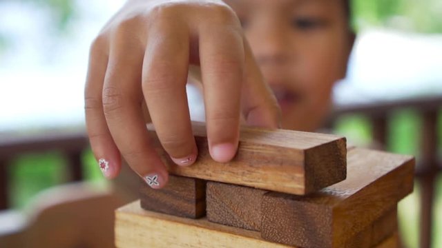 Happiness asian girl and friends having fun playing build block together. Recorded video in 60 fps