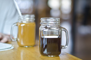 Two coffees in the mason jars of the coffee house. 