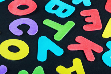 letters of the alphabet in different colors on a black background