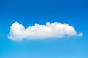 Single white fluffy cloud in the blue sky