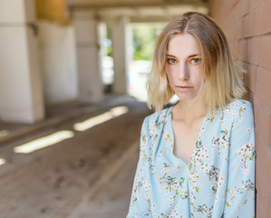 Summertime portrait of young woman with green eyes.