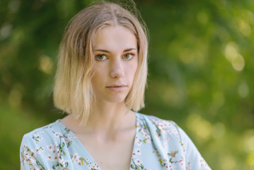 Summertime portrait of young woman with green eyes.