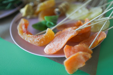 Young woman florist making fruit bouquet
