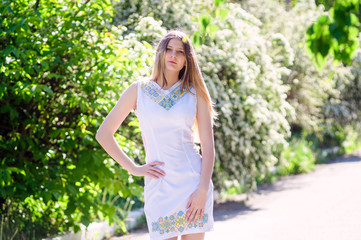 Fototapeta premium Portrait of a beautiful model in a white dress.