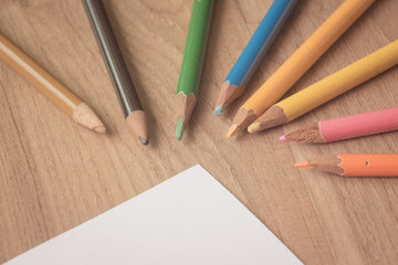 Colourful colour pencil on wooden background