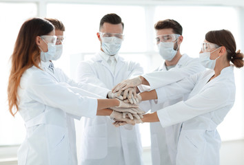 Close-up Photo Of Doctors Stacking Hand With Coworkers