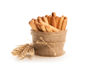 Salted  bread sticks with wheat ears isolated on white