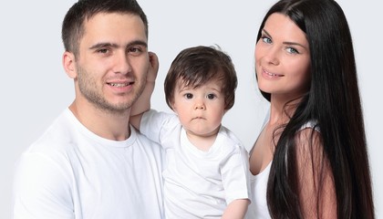 Fototapeta premium Happy family with newborn baby on a white background.