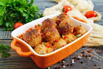Juicy meatballs in a spicy tomato sauce on a wooden table. Dish from minced meat.