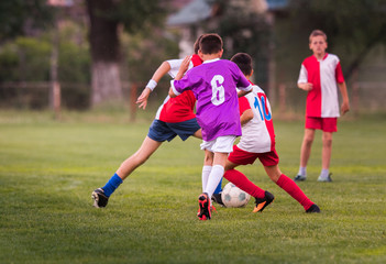 Young children players football match on soccer field