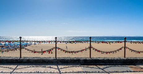 love locks, beach and ocean in Puerto del Carmen boardwalk, Lanzarote