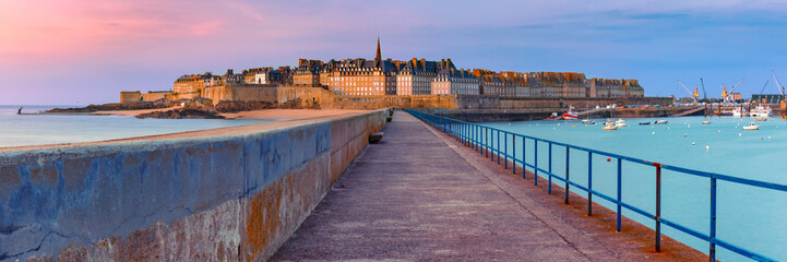 Panoramic view of walled city Saint-Malo with St Vincent Cathedral at sunset. Saint-Maol is famous...