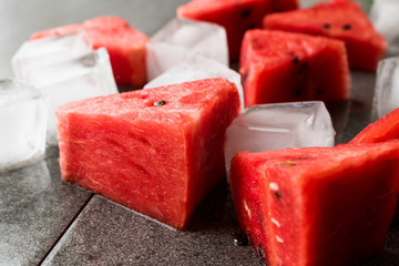 Watermelon Slices with Ice Cubes and Mint Leaves.