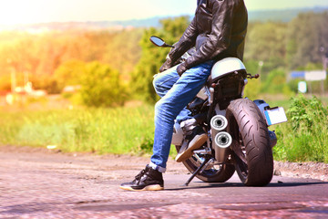 Naklejka premium Beautiful background with motorcyclist and his motorbike in travelling