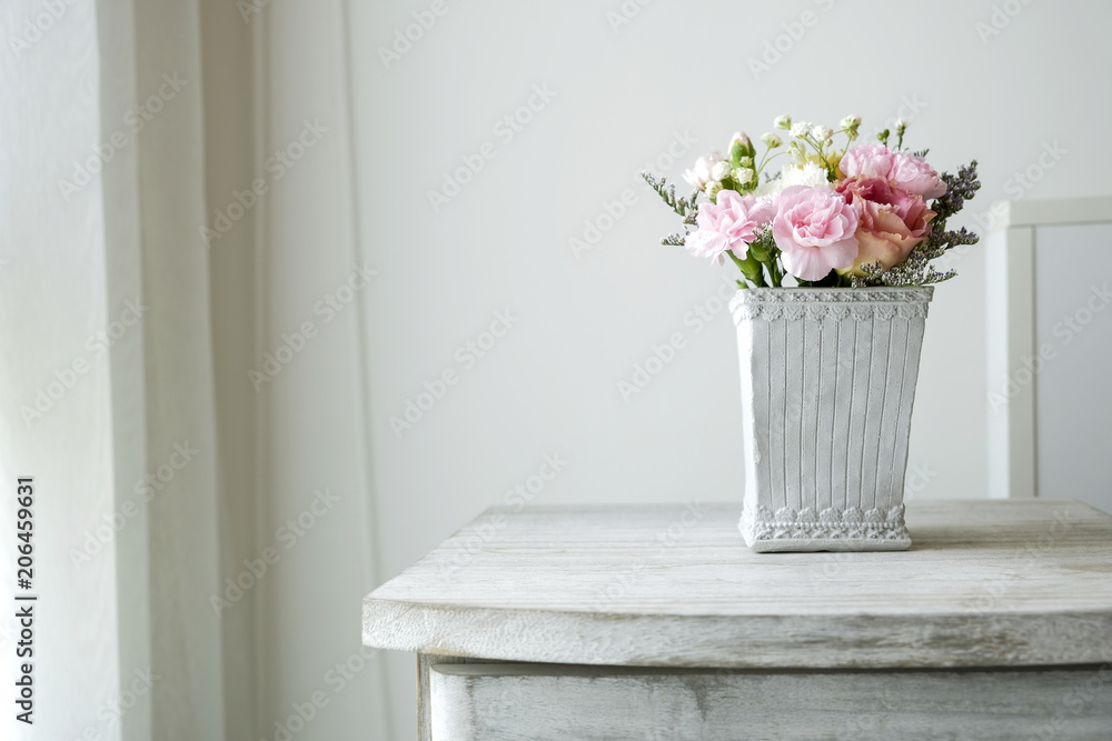 Wall mural carnation flower in cement pot on vintage cabinet at the bedroom