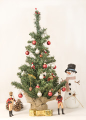 Decorated Christmas tree, with snowman and musicians standing around 