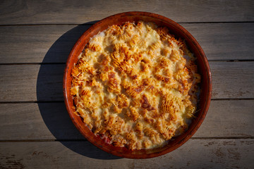 pasta Fisarmoniche gratin with cheese and tomato