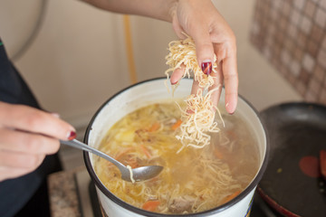 Noodle soup in a saucepan in the kitchen
