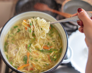 Noodle soup in a saucepan in the kitchen