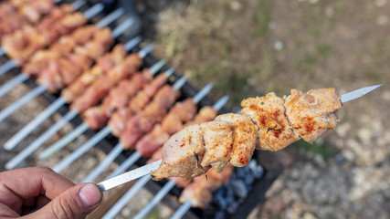 The meat is fried on sticks on charcoal
